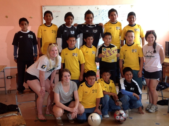 A few of the girls with one of the boys soccer teams we donated uniforms to.